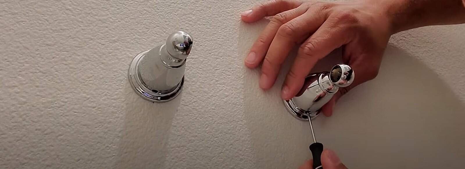 Insert a small flat-head screwdriver into the slot to release the tab