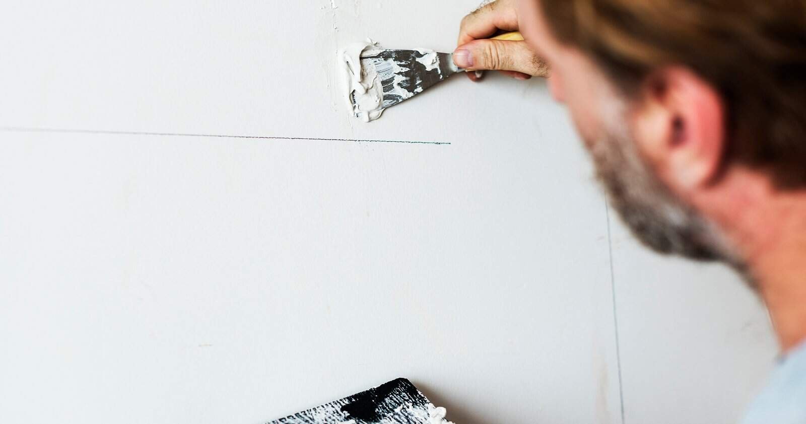 Construction worker painting the wall