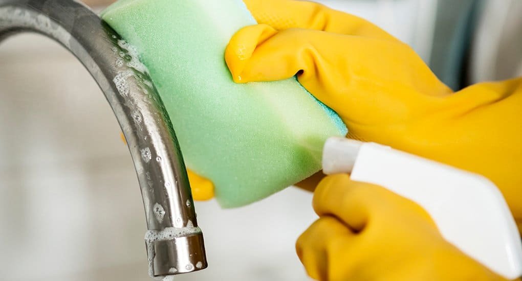 Cleaning sink faucet with mild dish soap