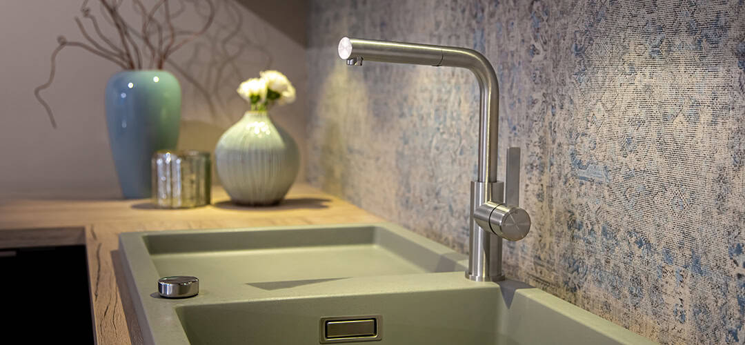 Chrome low-arc kitchen faucet with pull-out sprayer