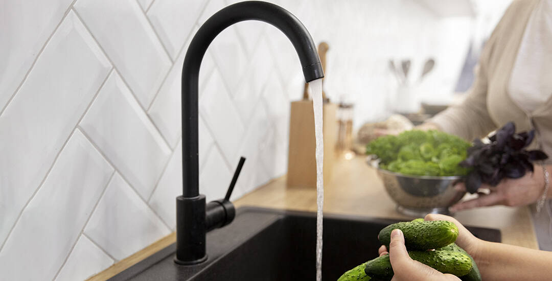 Using kitchen faucet to wash cucumber