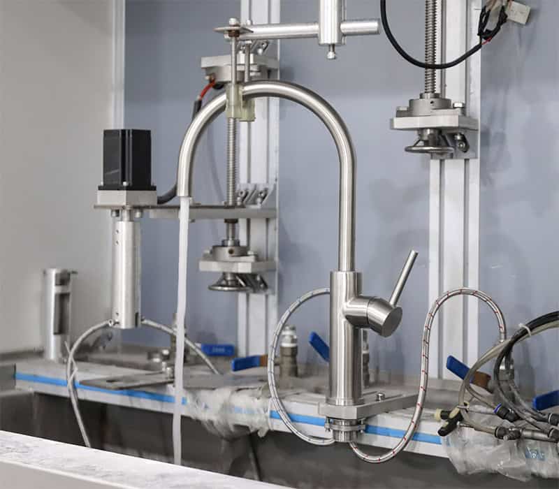 In-house quality control laboratory conducting strict hydrostatic pressure and life-cycle tests on a stainless steel kitchen faucet