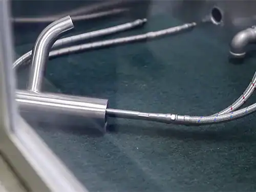 High-pressure water testing station checking stainless steel faucet body for leaks