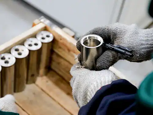 IPQC worker checking CNC machined stainless steel faucet parts on production line