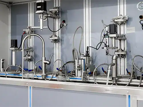Mechanical lifecycle testing rig evaluating faucet ceramic cartridge durability